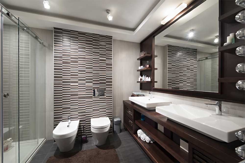 Dark timber double vanity with vessel basins and mirrored cabinets