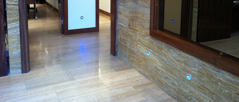 Pale stone floor tiles beside a textured stone feature wall