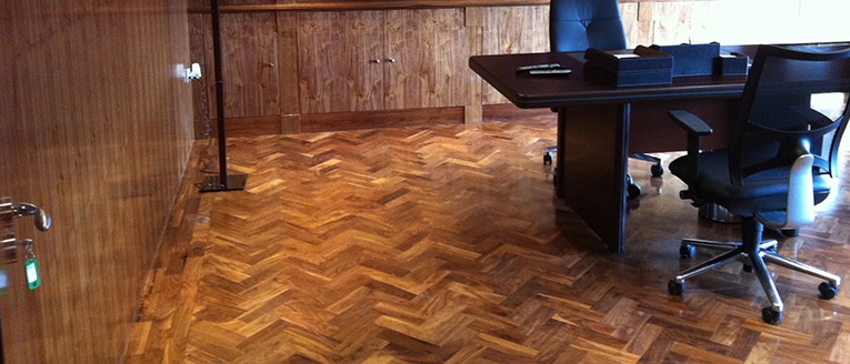 Restored herringbone parquet flooring in a home office
