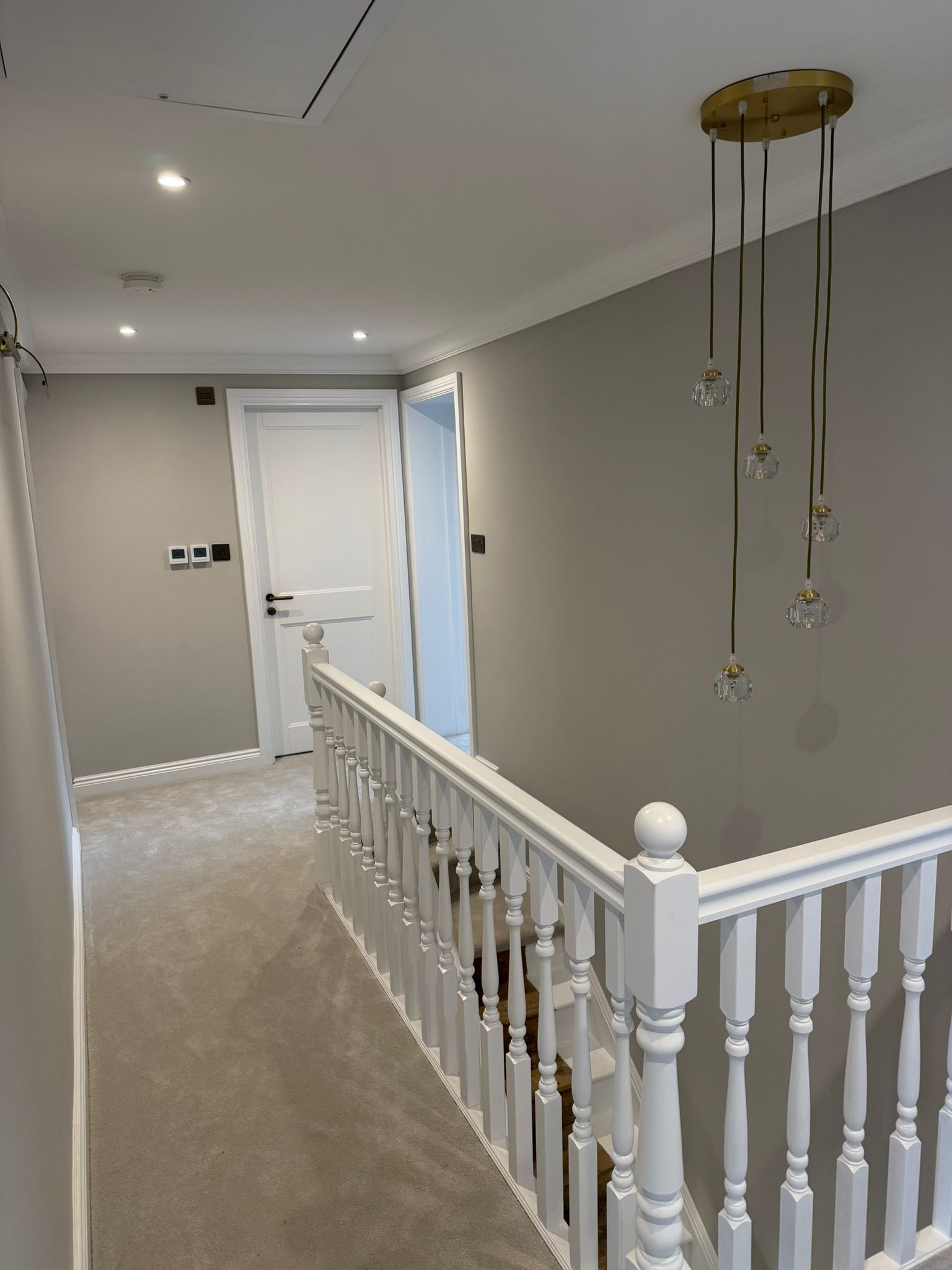 Finished pale timber landing beside a white balustrade