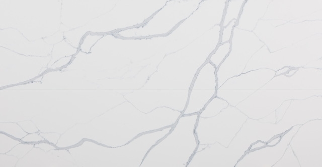 White stone surface with branching pale grey veins
