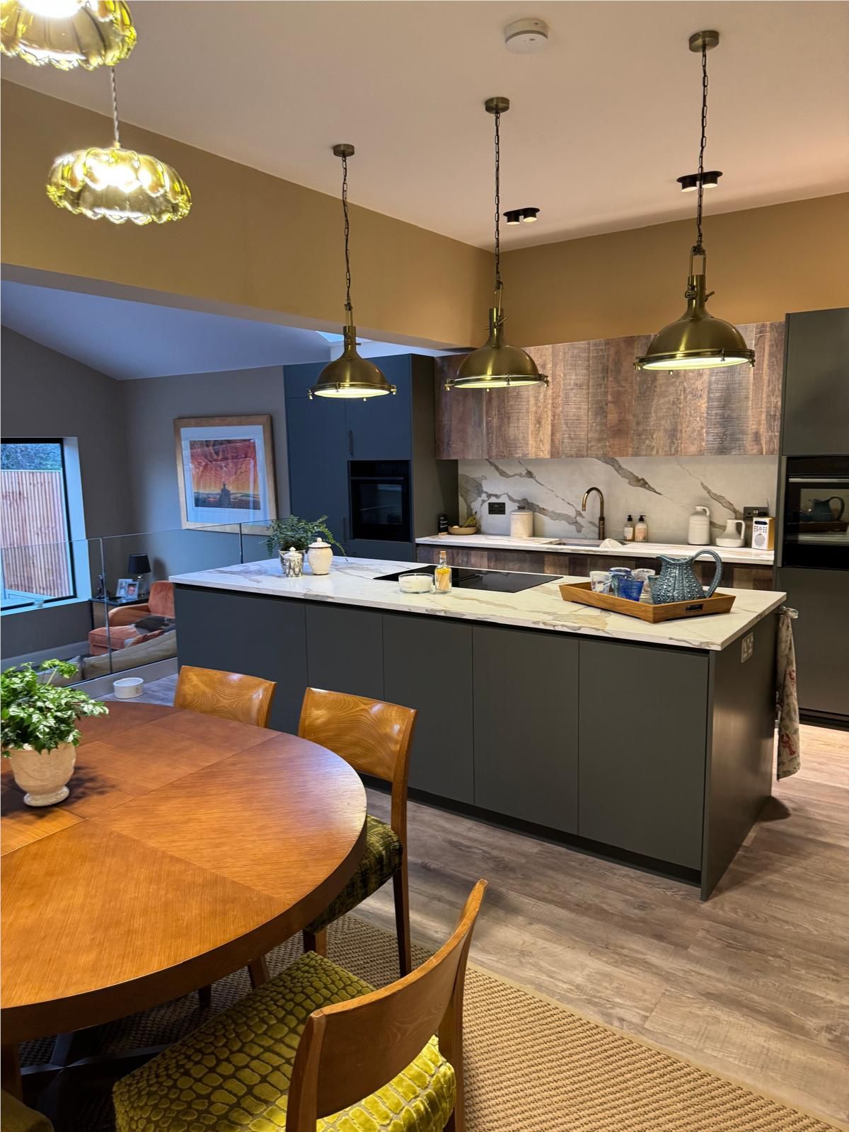 Stone-topped kitchen island viewed from the adjoining dining space